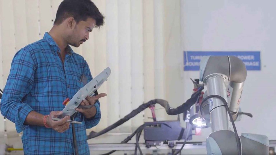 Application engineer programming UR5 for welding at PSG College, Coimbatore
