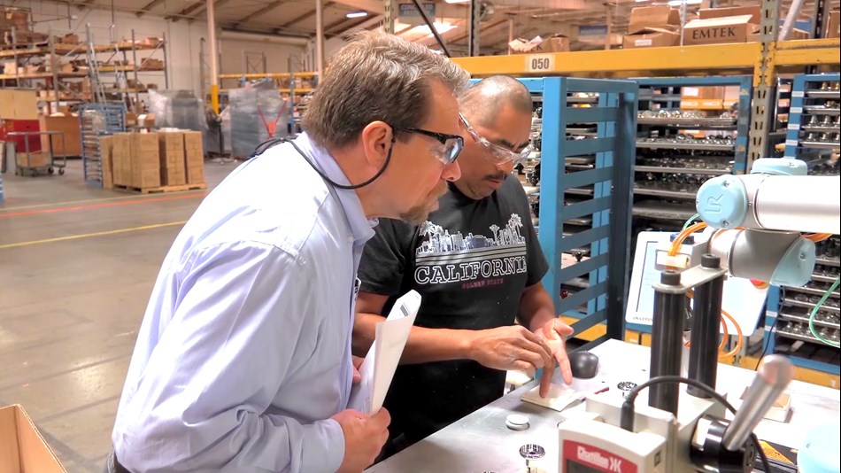 Birk Sorensen(left), VP of Engineering at EMTEK, oversees the gluing process. “The return on investment was just shy of 12 months, so it had worked out to be very advantageous for us,” he says.