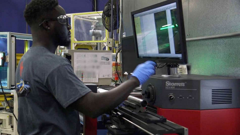 Operator tends CNC machine