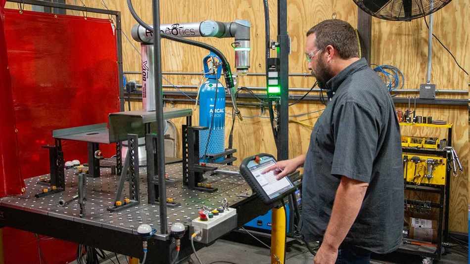 Man programs collaborative robot welding solution